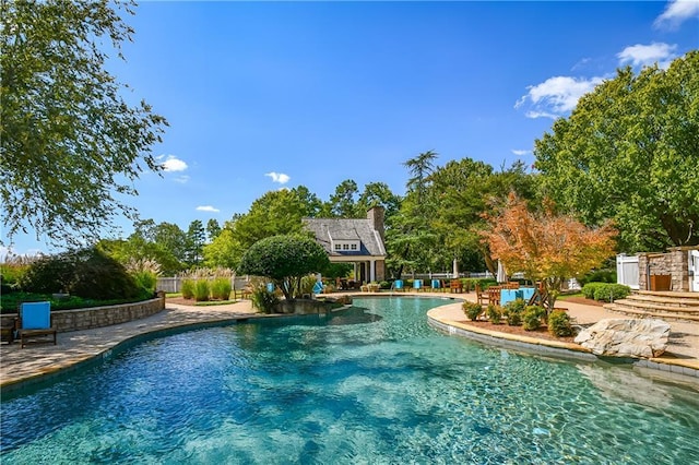 pool featuring fence and a patio