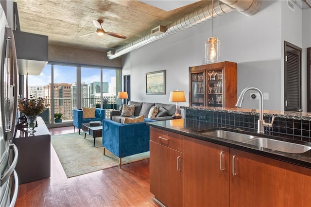 943 Peachtree St NE Unit 1910, Atlanta, GA 30309 - kitchen featuring brown cabinets, a sink, visible vents, wood finished floors, and a ceiling fan