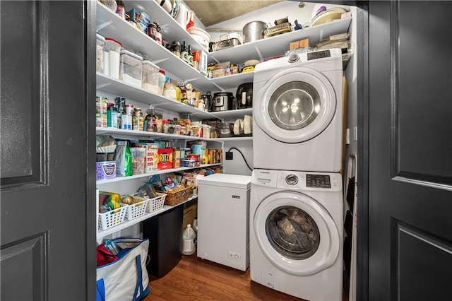 943 Peachtree St NE Unit 1910, Atlanta, GA 30309 - laundry room with stacked washer / dryer, laundry area, and wood finished floors