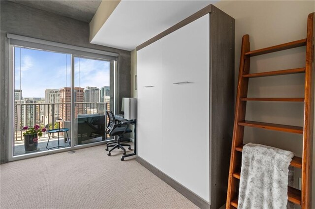 943 Peachtree St NE Unit 1910, Atlanta, GA 30309 - interior space with a view of city, baseboards, and carpet floors