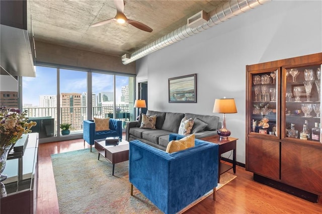 943 Peachtree St NE Unit 1910, Atlanta, GA 30309 - living area featuring a view of city, ceiling fan, wood finished floors, and visible vents