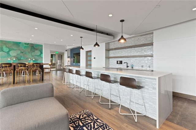 943 Peachtree St NE Unit 1910, Atlanta, GA 30309 - bar with recessed lighting, indoor wet bar, decorative light fixtures, and wood finished floors