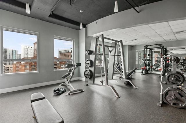 943 Peachtree St NE Unit 1910, Atlanta, GA 30309 - gym with a wealth of natural light, visible vents, a paneled ceiling, and baseboards