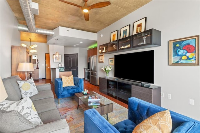943 Peachtree St NE Unit 1910, Atlanta, GA 30309 - living area featuring wood finished floors and ceiling fan with notable chandelier