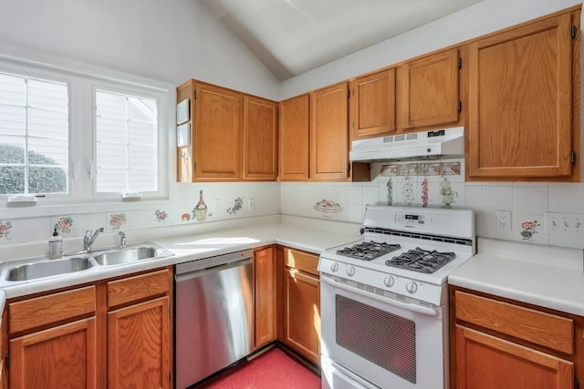 kitchen featuring gas range gas stove, a sink, under cabinet range hood, dishwasher, and tasteful backsplash