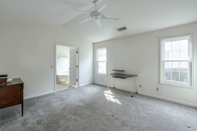 unfurnished bedroom with visible vents, carpet flooring, baseboards, and lofted ceiling