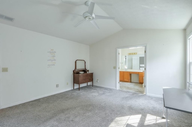 unfurnished bedroom featuring visible vents, ensuite bath, baseboards, lofted ceiling, and light colored carpet