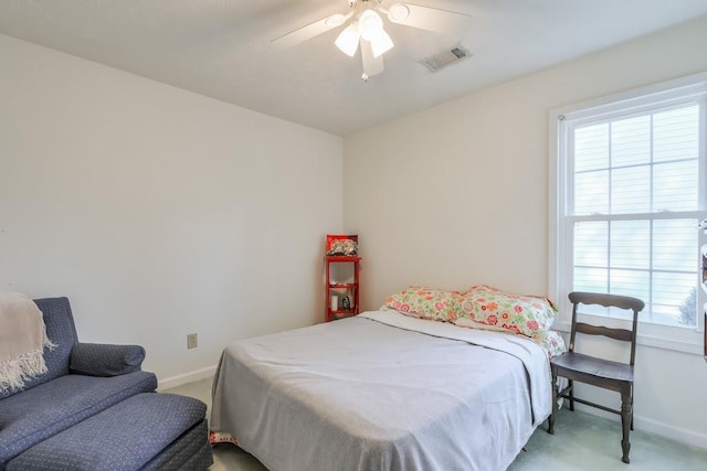 bedroom featuring ceiling fan, light colored carpet, visible vents, and baseboards