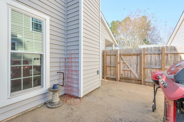 view of patio / terrace featuring a gate, grilling area, and fence