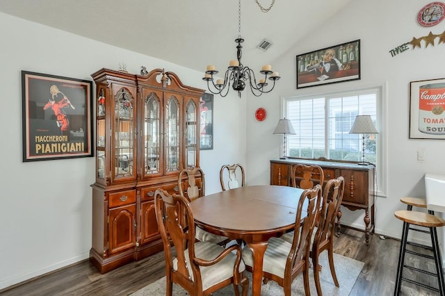 dining area featuring visible vents, lofted ceiling, dark wood-style floors, and a chandelier