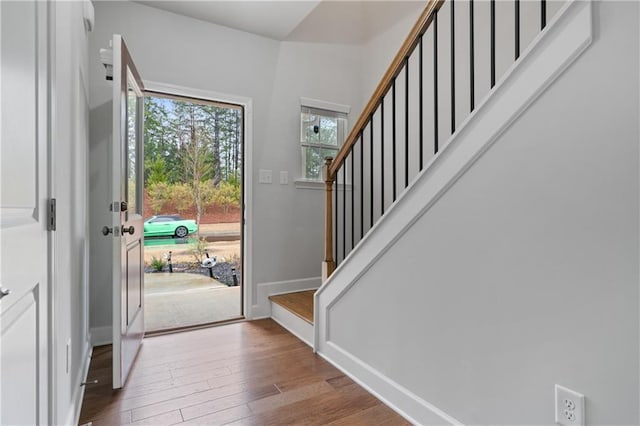 entrance foyer featuring stairway, baseboards, and wood-type flooring