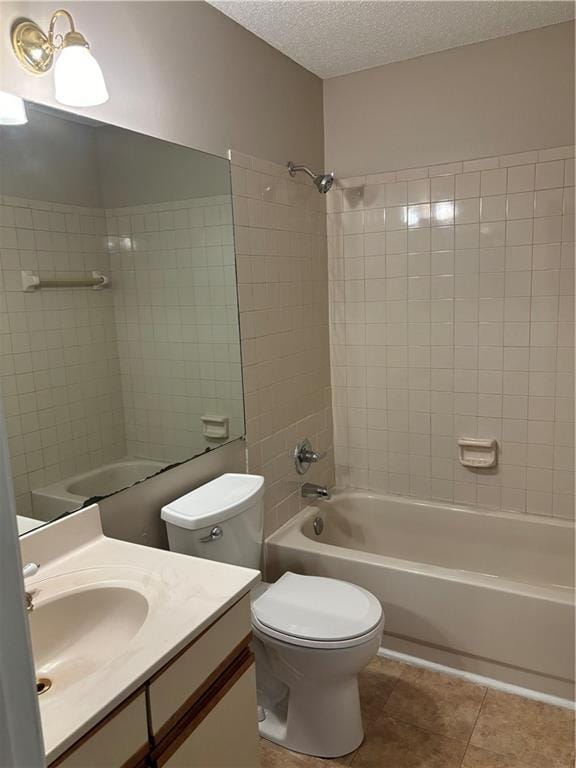 full bath with toilet, a textured ceiling, shower / bathing tub combination, tile patterned flooring, and vanity