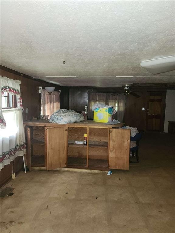 45 Oakwood Dr, Oglethorpe, GA 31068 - kitchen with wooden walls, a textured ceiling, and light floors