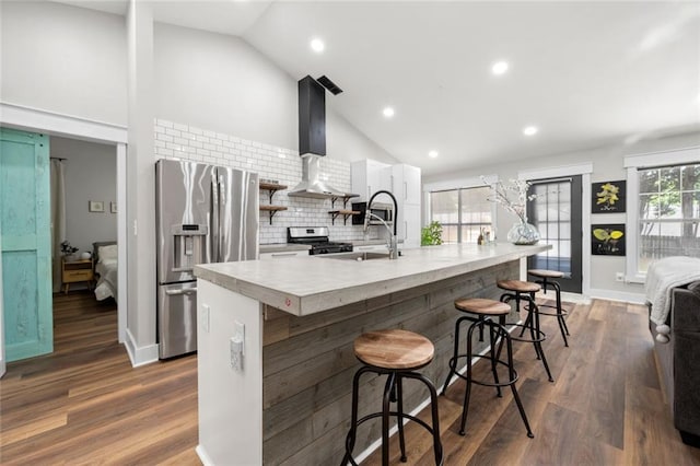 3313 Harmon Ridge Ct, Buford, GA 30519 - kitchen with stainless steel appliances, wall chimney exhaust hood, white cabinets, light countertops, and high vaulted ceiling