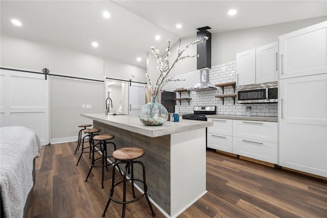 3313 Harmon Ridge Ct, Buford, GA 30519 - kitchen with appliances with stainless steel finishes, a barn door, open shelves, a center island with sink, and recessed lighting
