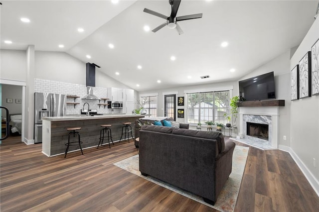 3313 Harmon Ridge Ct, Buford, GA 30519 - living room with a premium fireplace, ceiling fan, high vaulted ceiling, dark wood-style floors, and recessed lighting