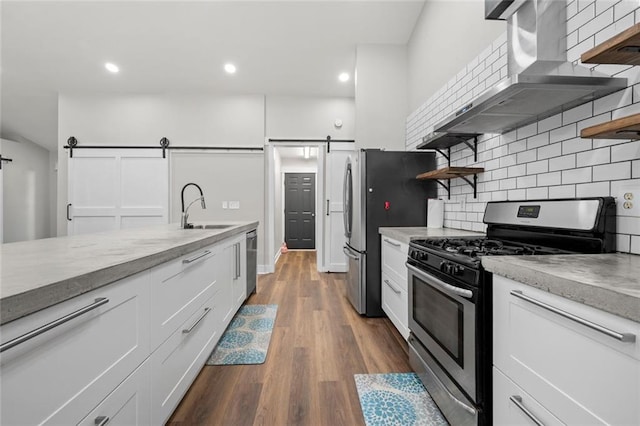 3313 Harmon Ridge Ct, Buford, GA 30519 - kitchen featuring a barn door, stainless steel appliances, open shelves, extractor fan, and a sink