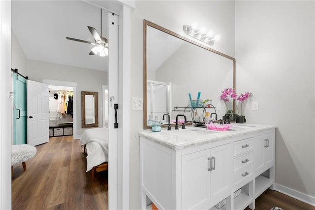 3313 Harmon Ridge Ct, Buford, GA 30519 - bathroom featuring double vanity, ceiling fan, wood finished floors, ensuite bath, and a shower with door