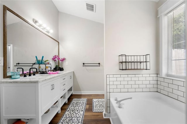 3313 Harmon Ridge Ct, Buford, GA 30519 - full bath featuring double vanity, a bath, healthy amount of natural light, and wood finished floors
