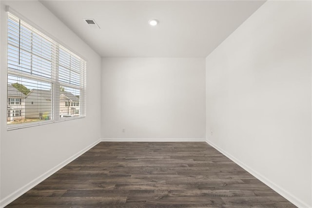 unfurnished room with dark hardwood / wood-style floors