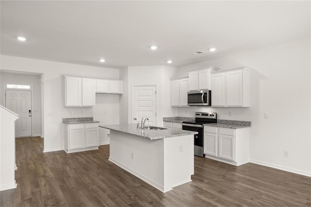 kitchen with a center island with sink, white cabinets, sink, and appliances with stainless steel finishes