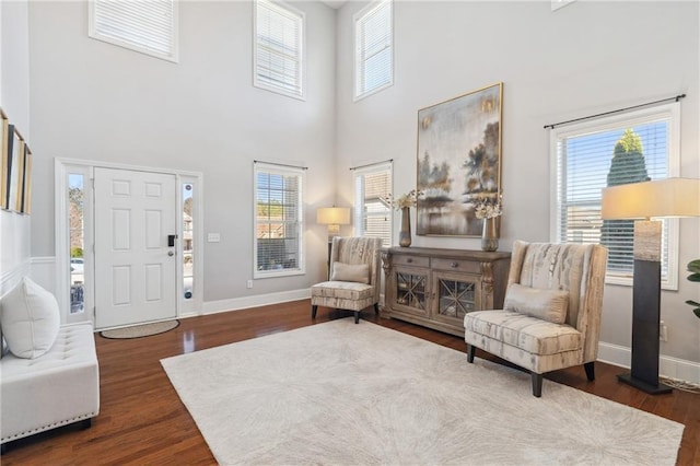 living area featuring dark wood finished floors and baseboards