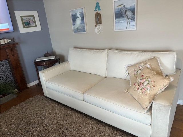 living area with baseboards and wood finished floors