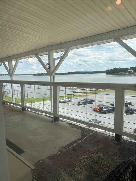 view of patio / terrace with a water view and a balcony