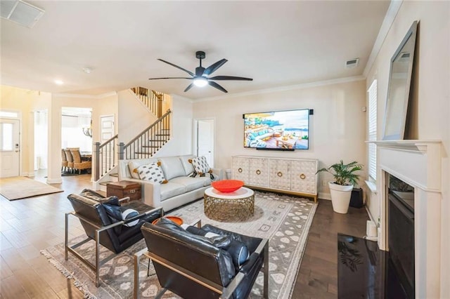 living room featuring plenty of natural light, stairway, and wood finished floors