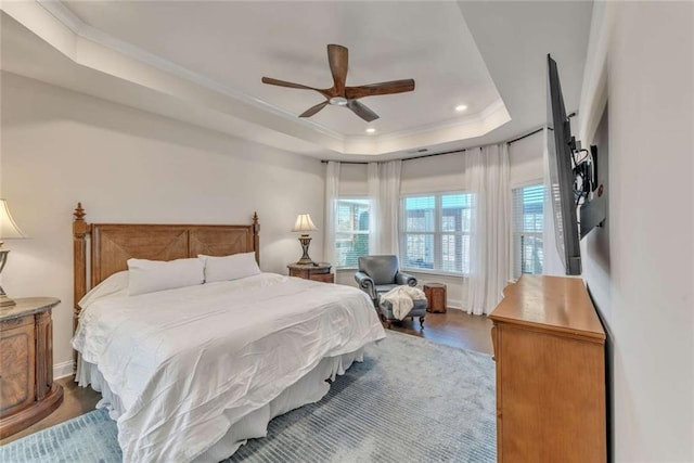 bedroom with ceiling fan, ornamental molding, wood finished floors, a tray ceiling, and recessed lighting