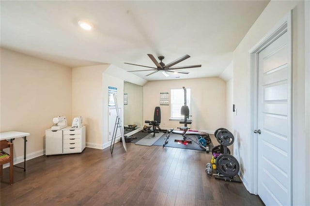 exercise room featuring dark wood-style floors, a ceiling fan, and baseboards