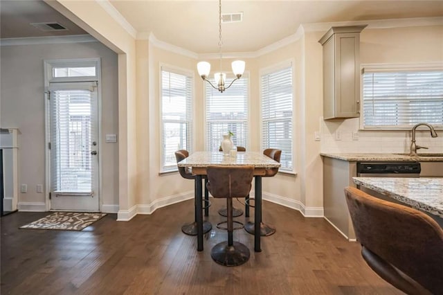 dining room featuring baseboards, dark wood-style flooring, visible vents, and crown molding