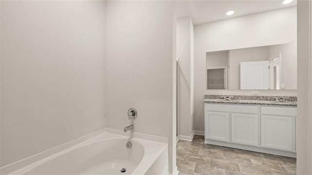 bathroom with a bath and vanity