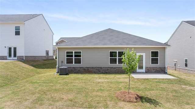 rear view of property with a patio, central air condition unit, and a lawn