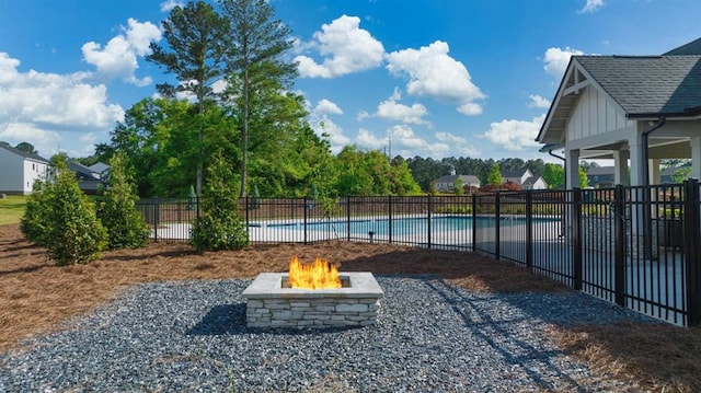 view of yard with a fenced in pool and a fire pit