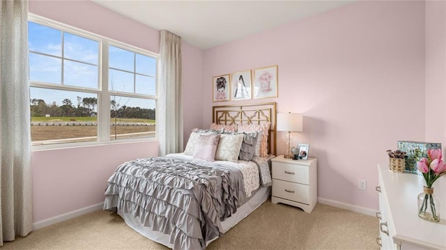 bedroom featuring multiple windows and light colored carpet