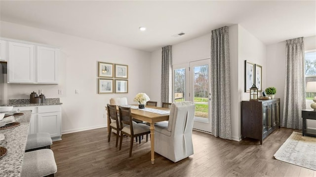 dining area with dark hardwood / wood-style flooring