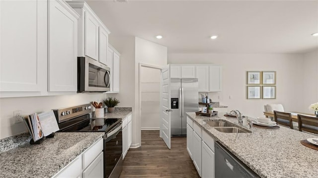 kitchen featuring dark wood-type flooring, white cabinetry, stainless steel appliances, and sink