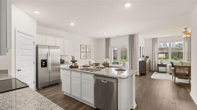 kitchen with dark wood-type flooring, white cabinets, stainless steel appliances, and sink