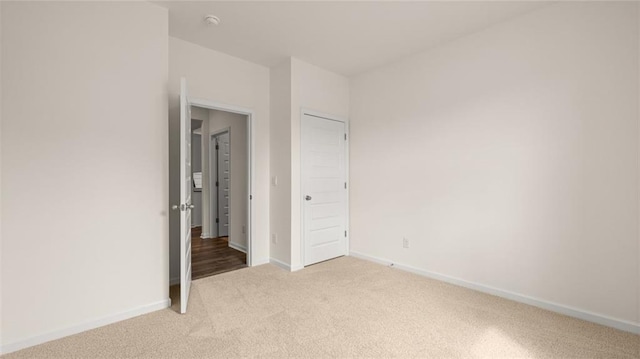 unfurnished bedroom featuring light carpet