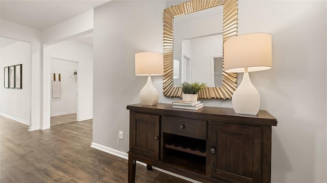 corridor with hardwood / wood-style flooring