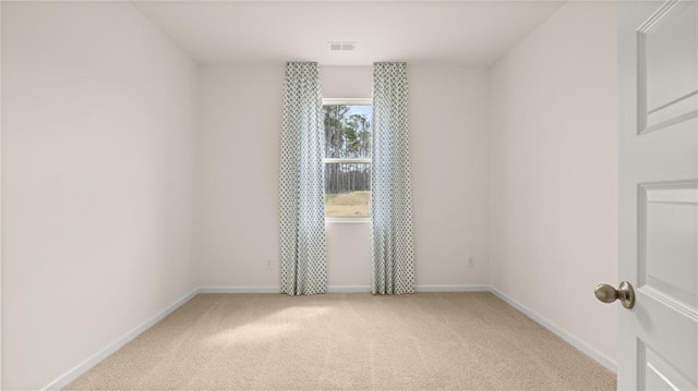 empty room featuring light colored carpet