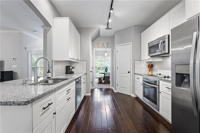 3174 Vickery Dr NE, Marietta, GA 30066 - kitchen featuring appliances with stainless steel finishes, a sink, light stone counters, dark wood-style floors, and backsplash