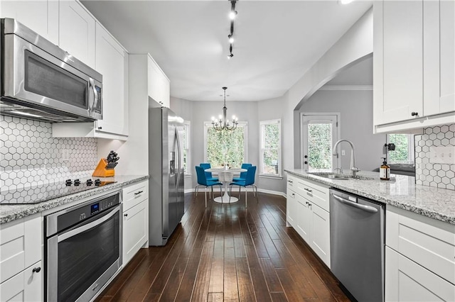 3174 Vickery Dr NE, Marietta, GA 30066 - kitchen featuring stainless steel appliances, a chandelier, white cabinets, and dark wood-style floors