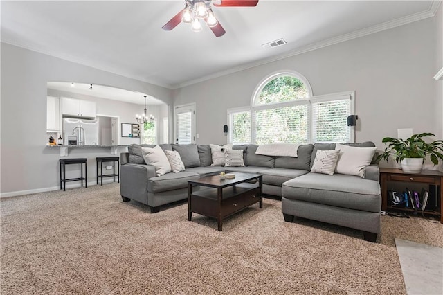 3174 Vickery Dr NE, Marietta, GA 30066 - living area featuring a ceiling fan, a chandelier, ornamental molding, baseboards, and light colored carpet