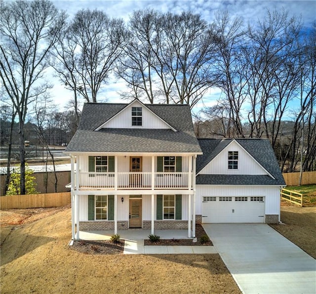 view of front of house featuring covered porch, roof with shingles, and a garage