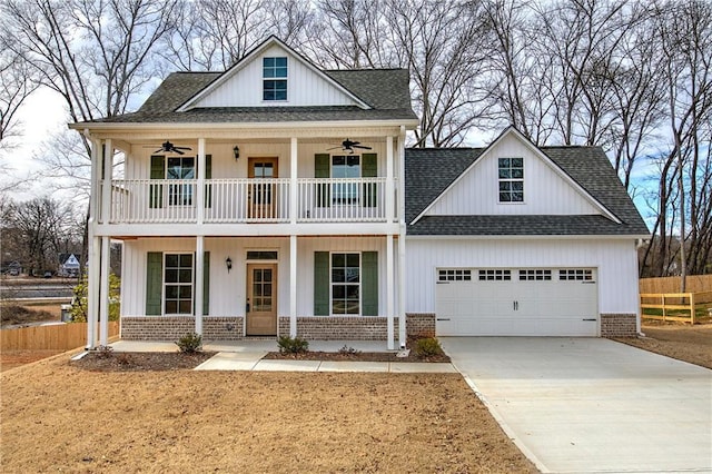 view of front of house featuring ceiling fan, a garage, and a balcony