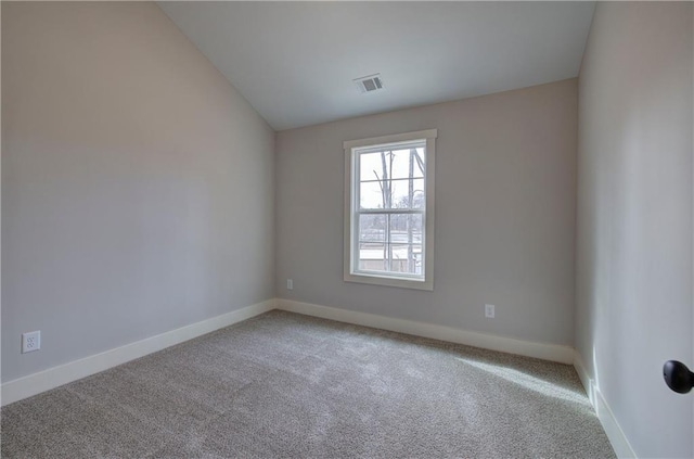 unfurnished room with vaulted ceiling, carpet, visible vents, and baseboards