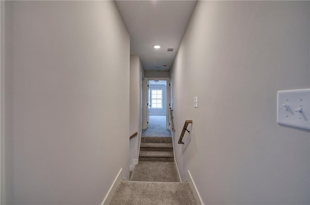 stairway featuring carpet flooring, visible vents, and baseboards