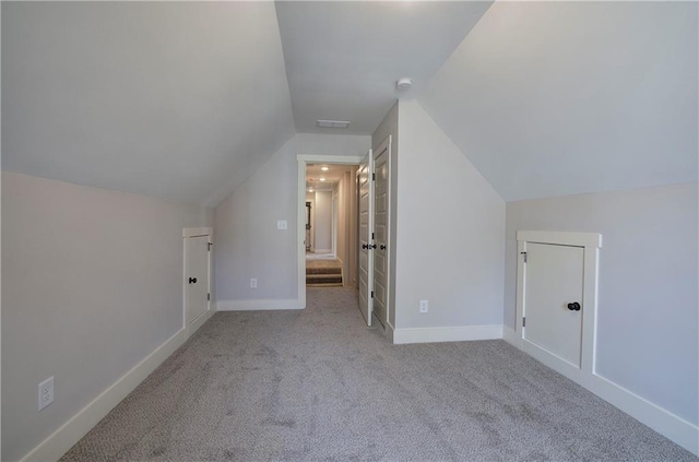 bonus room featuring vaulted ceiling, carpet flooring, and baseboards